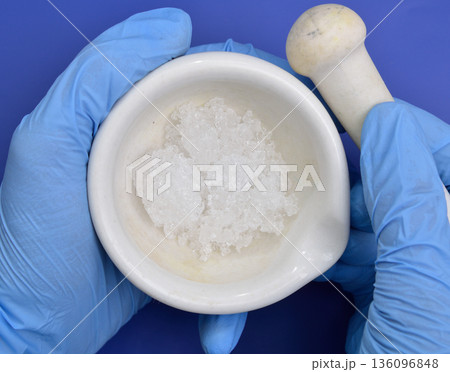 Cadmium nitrate powder on beige background 136096848