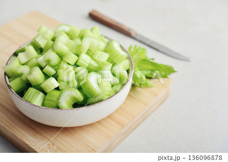 Chopped stalks of fresh celery in a bowl 136096878
