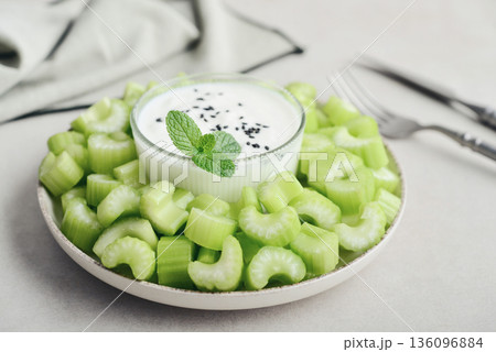 Chopped celery stalks with greek yogurt 136096884