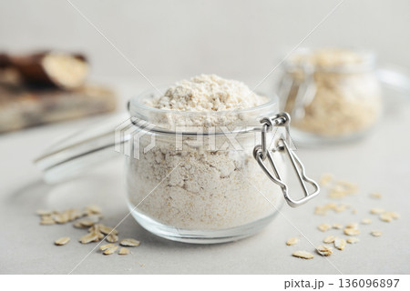 Oat flour in glass jar Oat flour in glass jar 136096897
