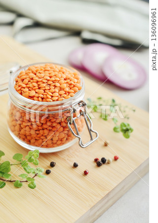Raw dry red lentils with spices and herbs in a glass jar Raw dry red lentils with spices and herbs in a glass jar 136096961