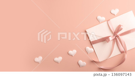 Love letter envelope with pink ribbon and hearts 136097143