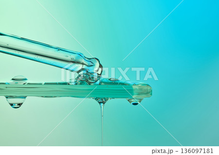 Dropper applying liquid chemical serum onto glass surface Dropper applying liquid chemical serum onto glass surface 136097181