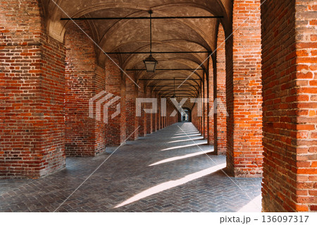 Symmetrical brick arcade in Sabbioneta, Italy, with long perspective Symmetrical brick arcade in Sabbioneta, Italy, with long perspective 136097317