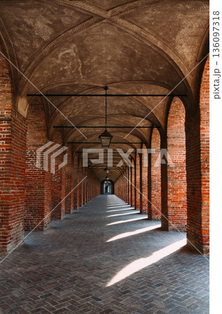 Symmetrical brick arcade in Sabbioneta, Italy, with long perspective Symmetrical brick arcade in Sabbioneta, Italy, with long perspective 136097318