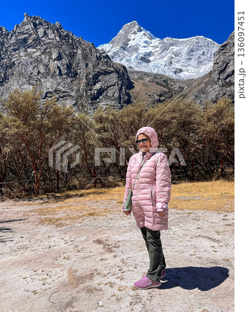 An elderly woman stands in front of the Llanganuco lagoon in the province of Ancash An elderly woman stands in front of the Llanganuco lagoon in the province of Ancash 136097451