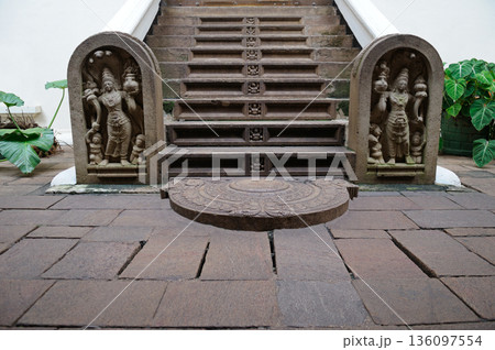 Ancient Temple Entrance Featuring Sandakada Pahana Moonstone and Guardstones 136097554
