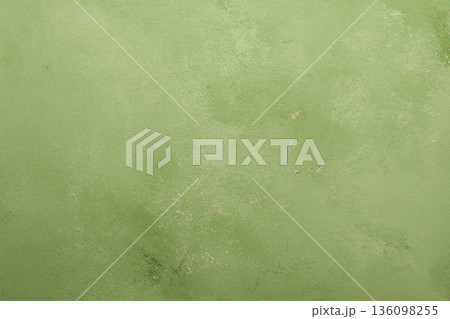 A light green surface is visible with different textures and small spots. It has an irregular pattern, and could work as a solid background A light green surface is visible with different textures and small spots. It has an irregular pattern, and could work as a solid background 136098255
