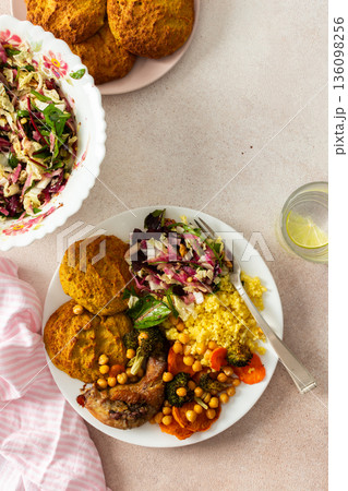A filling, balanced breakfast with lentil and zucchini pancakes, millet, baked chicken neck, roasted sweet potatoes, broccoli, carrots, chickpeas, and a fresh salad with radish, sprouts, and nuts A filling, balanced breakfast with lentil and zucchini pancakes, millet, baked chicken neck, roasted sweet potatoes, broccoli, carrots, chickpeas, and a fresh salad with radish, sprouts, and nuts 136098256