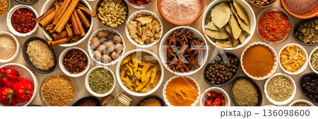 Collection of assorted spices and herbs spread on a beige background, blending exotic aromas and colors to inspire flavorful cooking, banner Collection of assorted spices and herbs spread on a beige background, blending exotic aromas and colors to inspire flavorful cooking, banner 136098600