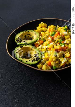 Colorful salad features boiled egg, tender chicken breast, and fresh vegetables like potatoes, carrots, and green peas, served with ripe avocado sprinkled with sesame seeds and olive oil Colorful salad features boiled egg, tender chicken breast, and fresh vegetables like potatoes, carrots, and green peas, served with ripe avocado sprinkled with sesame seeds and olive oil 136098606