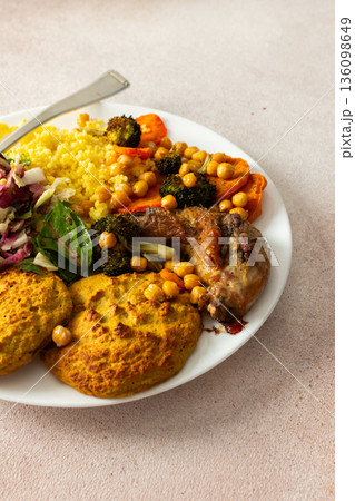 A wholesome breakfast with lentil-zucchini pancakes, millet, roasted chicken neck, sweet potatoes, broccoli, carrots, chickpeas, and a fresh mix salad with radish, nuts, and mung bean sprouts A wholesome breakfast with lentil-zucchini pancakes, millet, roasted chicken neck, sweet potatoes, broccoli, carrots, chickpeas, and a fresh mix salad with radish, nuts, and mung bean sprouts 136098649