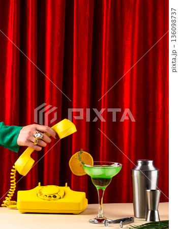 Retro green cocktail against a red curtain 136098737