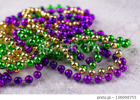Vibrant Mardi Gras background with mask, beads, and festive decorations Vibrant Mardi Gras background with mask, beads, and festive decorations 136098755