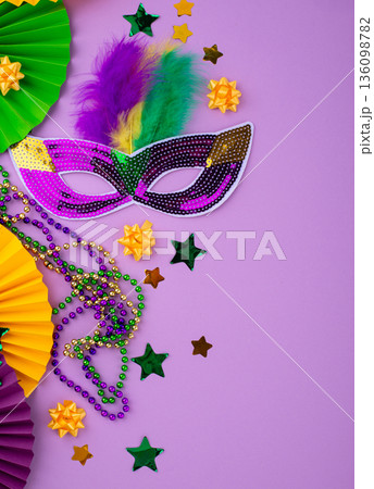 Vibrant Mardi Gras background with mask, beads, and festive decorations Vibrant Mardi Gras background with mask, beads, and festive decorations 136098782