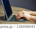 Woman typing on tablet keyboard during digital work closeup. 136098945
