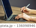 Hands using tablet with keyboard and stylus 136098946