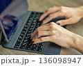Woman typing on tablet keyboard during digital work closeup. 136098947