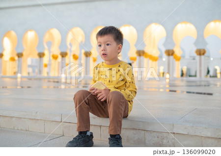 Young Boy Visiting Sheikh Zayed Grand Mosque in Abu Dhabi United Arab Emirates Young Boy Visiting Sheikh Zayed Grand Mosque in Abu Dhabi United Arab Emirates 136099020