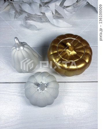 Decorative gypsum products. A pumpkin-shaped box in a golden color. On white boards. Photo from above Decorative gypsum products. A pumpkin-shaped box in a golden color. On white boards. Photo from above 136100009