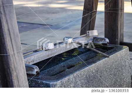 Japanese metal dipper prepares for people who visit the shrine for clean mouth, hand, face. 136100353
