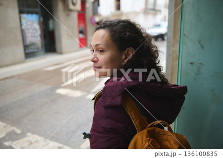 Candid Street Portrait Of A Woman With Backpack Waiting On The Sidewalk 136100835