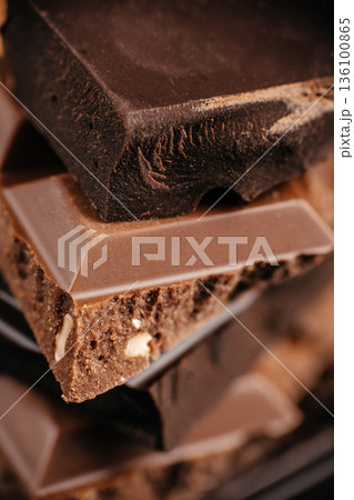 Premium chocolate bars with hazelnuts, dark and milk chocolate macro texture Premium chocolate bars with hazelnuts, dark and milk chocolate macro texture 136100865
