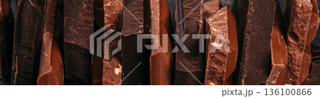Assorted dark and milk chocolate pieces texture background 136100866