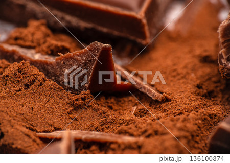 Chocolate pieces in cocoa powder close up 136100874