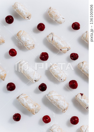 Powdered sugar cherry rugelach cookies pattern on white background, top view Powdered sugar cherry rugelach cookies pattern on white background, top view 136100906