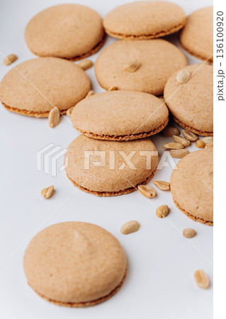 Peanut macarons flat lay on white background, minimal sweet dessert 136100920