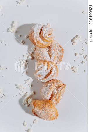 Powdered sugar pastries pattern on white background, flat lay 136100921