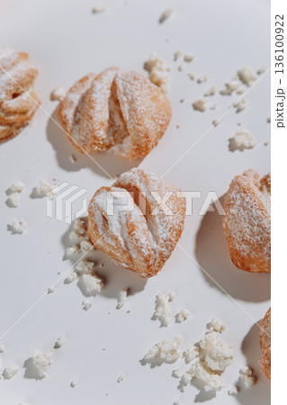 Powdered sugar pastries close-up on white background, soft shadows Powdered sugar pastries close-up on white background, soft shadows 136100922