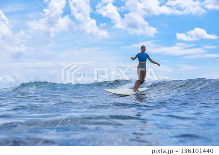 Female Surfer Merging Mindfulness With Sea Calmness And Breezes 136101440
