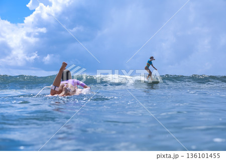 Female Instructor Showing How To Ride Waves With Enthusiasm And Movement 136101455