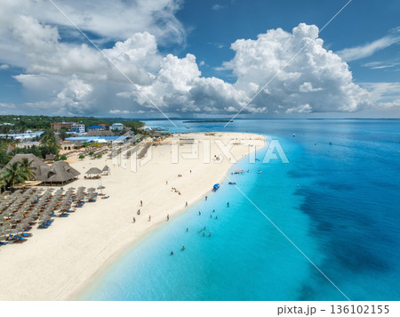 Aerial view of tropical sandy beach, blue sea and rain clouds 136102155