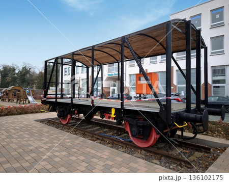 A restored wooden railway platform car on the tracks 136102175