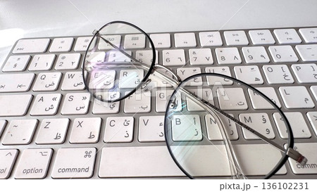 Closeup Keyboard Glasses, Clear Lens Focus On Work, Detailed Shot Of Glasses And Keyboard Setup, Minimalist Workspace With Glasses Highlighting Focus And Organization Closeup Keyboard Glasses, Clear Lens Focus On Work, Detailed Shot Of Glasses And Keyboard Setup, Minimalist Workspace With Glasses Highlighting Focus And Organization 136102231