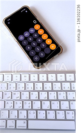 Smartphone Calculator Open Above Keyboard, Dosage Calculation For Medication By Nurse, Precise Numeric Interface And Bright Clean Desk For Accurate Administration 136102236