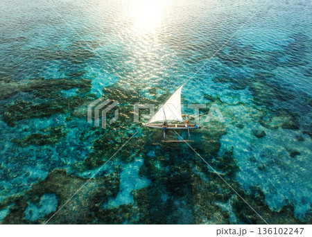 Aerial view of the sailboat on blue sea at sunset in summer 136102247