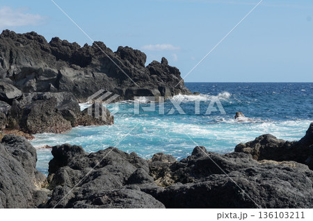 Natural lava pool with turquoise Atlantic water surrounded by dark basalt rocks at Zona Balnear Ponta do Admoiro on Pico Island Natural lava pool with turquoise Atlantic water surrounded by dark basalt rocks at Zona Balnear Ponta do Admoiro on Pico Island 136103211