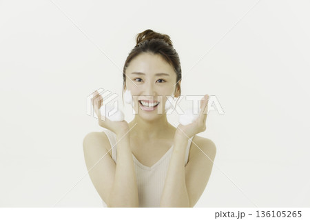 白背景の洗顔の泡を両手に持ってほほえむ若い日本人女性 白背景の洗顔の泡を両手に持ってほほえむ若い日本人女性 136105265