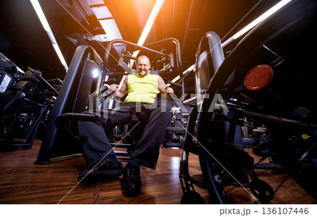 Disabled man training in the gym of rehabilitation center Disabled man training in the gym of rehabilitation center 136107446