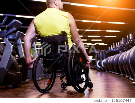 Disabled man training in the gym of rehabilitation center Disabled man training in the gym of rehabilitation center 136107447