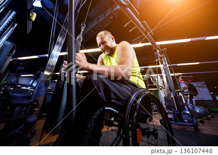 Disabled man training in the gym of rehabilitation center 136107448