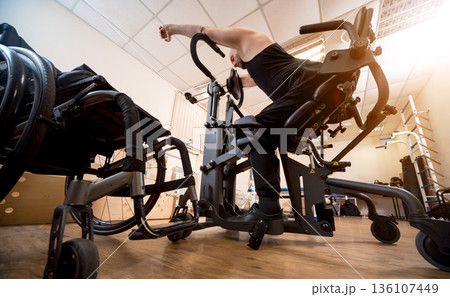 Disabled man training in the gym. Rehabilitation center 136107449