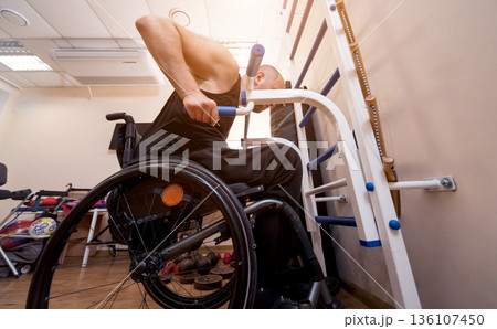 Disabled man training in the gym. Rehabilitation center Disabled man training in the gym. Rehabilitation center 136107450