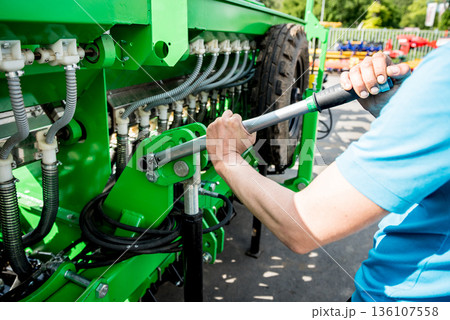 The mechanics repair combine harvester. Modern agricultural machinery 136107558