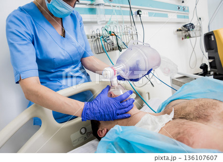 Doctors give resuscitation to a male patient in the emergency room. 136107607