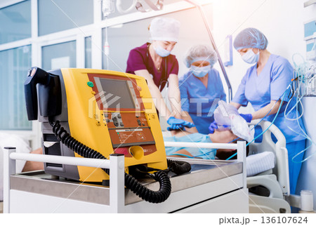 Doctors give resuscitation to a male patient in the emergency room. Doctors give resuscitation to a male patient in the emergency room. 136107624